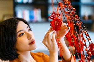 Woman putting up Chinese new year decorations